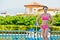 Woman stands near to handrails at poolside