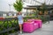 A woman stands next to a pink bench with flowers on the Kazan embankment