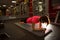 Woman stands in a plank in the gym. Sportswear, training for the press and muscle strength, strengthening the abdomen and back.