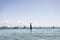 Woman stands upside down on a surfboard at beach