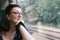 Woman staring thoughtfully out of train window