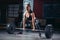 Woman starting barbell exercise standing squat stance.