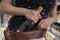 Woman is stealing bottle of wine and hiding it in handbag in supermarket