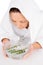 Woman steaming face with rosemary in bowl of water