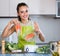 Woman steaming salmon and vegetables