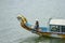 Woman steering dragon boat on Perfume River in Hue Vietnam