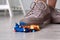 Woman stepping on dropped cupcake indoors, closeup. Troubles happen