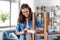 woman sticking masking tape to table for repaint