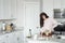 Woman stirring in copper bowls in the kitchen