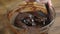 Woman stirring delicious chocolate cream in bowl with spatula on table.