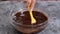 Woman stirring delicious chocolate sauce in bowl.