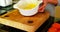 Woman stirring egg yolk on bowl in kitchen at home 4k