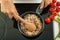 Woman stirring rice in saucepan on stove, closeup