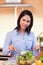 Woman stirring salad in the kitchen