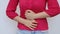 Woman stomach ache. Woman having a stomachache, or menstruation pain with white background. Health care and medical