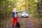 A woman stops a car on a forest road