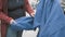 Woman in store chooses to buy blue kimono for wrestling. Hands close up shot