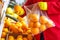 A woman in a store puts oranges in a bag