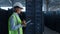 Woman storehouse employee noting shipment details examining factory warehouse