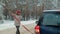 Woman with a straw car on the road in winter