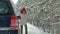 Woman with a straw car on the road in winter