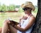 Woman in a straw hat reading a book