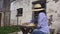 Woman in straw hat relaxing near chess outdoor