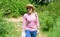 Woman in straw hat walking in nature background. Woman going picnic in nature. Woman sunglasses carrying backpack