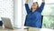 Woman streching arm raised sitting incorrect position home office desk. Back side of young asian woman tired from work body stress