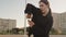 Woman street dancer with long hair deftly folds her hands over chest in dance close up. Young caucasian girl in a black