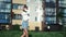 Woman street dancer performing dance movement in summer city sunny day. Wide shot on RED camera