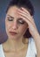 Woman stressed headache against blue background