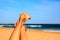 Woman stretched her feet relaxed on the beach in the sky