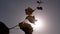 Woman Stretches Hand with a Dry Leafs into the Sky, to Sun on Sunset. Close up