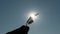 Woman Stretches Hand with a Maple Leaf into the Sky, Zoom. Close up