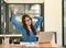 Woman stretches her arms when tired in the office, business woman relaxes, office syndrome