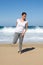 Woman stretches leg on beach