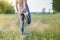 Woman stretches legs before jogging