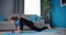 Woman stretching body on blue yoga mat
