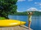 Woman stretching before diving off the dock into lake