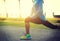 woman stretching legs before run at tropical park