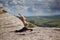 Woman stretching on mountain. Yoga, Pilates or Contemplation idea. Comfy sportswear for workout. Fresh air.