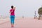 Woman stretching and warming up on the promenade