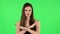 Woman strictly gesturing with hands crossed making X shape meaning denial saying NO. Green screen