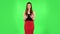 Woman strictly gesturing with hands shape meaning denial saying NO. Green screen