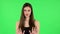 Woman strictly gesturing with hands shape meaning denial saying NO. Green screen