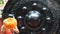 Woman strikes a gong in a Buddhist temple