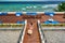 Woman in striped swimsuit on beach patio