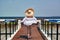 Woman in striped swimsuit on beach patio