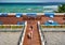 Woman in striped swimsuit on beach patio